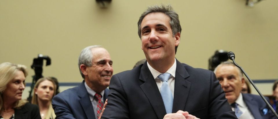 Michael Cohen, former attorney and fixer for President Donald Trump, shares a moment with his lawyer Lanny Davis as he testifies before the House Oversight Committee on Capitol Hill Feb. 27, 2019 in Washington, D.C. (Photo by Alex Wong/Getty Images)