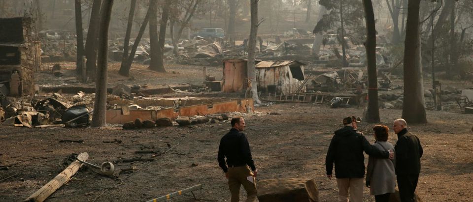 U.S. President Donald Trump visits the Skyway Villa Mobile Home and RV Park, a neighborhood recently destroyed by the Camp fire, with Governor of California Jerry Brown, right, Mayor Jody Jones, second from right and Brock Long, in Paradise, California, U.S., November 17, 2018. REUTERS/ Leah Millis