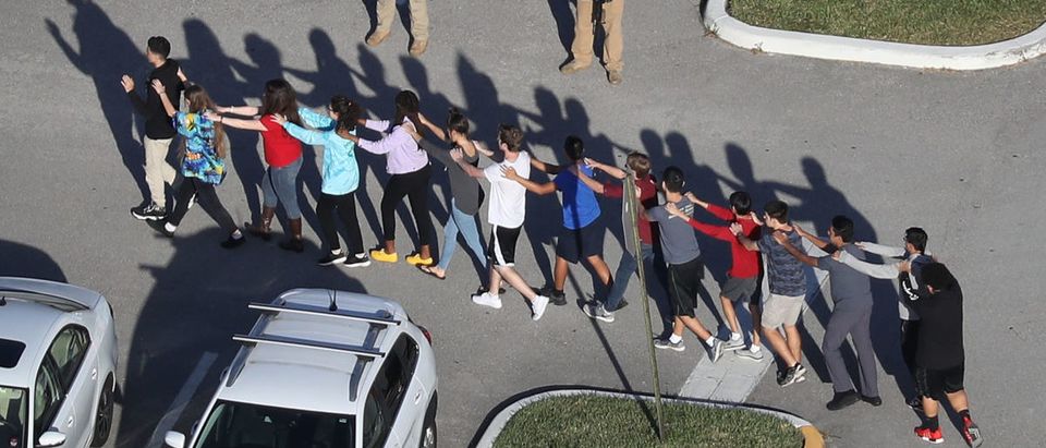 People are brought out of the Marjory Stoneman Douglas High School after a shooting at the school that reportedly killed and injured multiple people on Feb. 14, 2018 in Parkland, Florida. Getty Images/ Joe Raedle