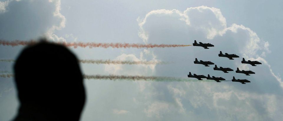 Pilots from the Surya-Kiran aerobatic demonstration team perform on the outskirts of Bangalore