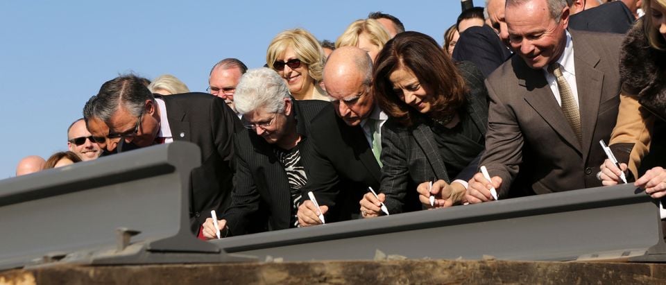 California Governor Jerry Brown and his wife, Anne Gust, sign a railroad rail during a ceremony for the California High Speed Rail in Fresno