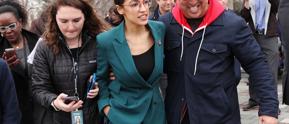 U.S. Representative Ocasio-Cortez moves through a group of reporters after a news conference for the proposed "Green New Deal" at the U.S. Capitol in Washington