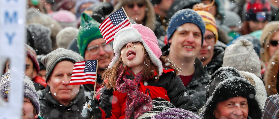 A girl tries to catch snowflakes on her tongue before the start of a rally for U.S. Senator Amy Klobuchars bid for the 2020 Democratic presidential nomination in Minneapolis, Minnesota, U.S., February 10, 2019. REUTERS/Eric Miller