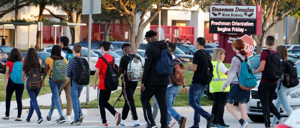 Students cross a street to enter for the first day of classes at Marjory Stoneman Douglas High School in Parkland, Florida, U.S. August 15, 2018. REUTERS/Joe Skipper