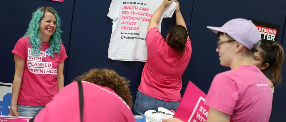 Volunteers with Planned Parenthood of Arizona set up at a bilingual healthcare town hall sponsored by local organizations that work in Latino voter outreach, disability advocacy and community health at the Ability360 Center in Phoenix, Arizona, U.S. July 5, 2017. Senators John McCain and Jeff Flake (R-AZ) were invited but declined to attend. Picture taken July 5, 2017. REUTERS/Caitlin O'Hara