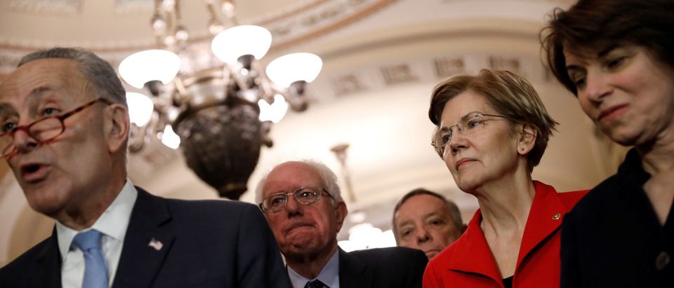 Senate Minority Leader Chuck Schumer, accompanied by Sen. Bernie Sanders (I-VT), Sen. Elizabeth Warren (D-MA), Sen. Amy Klobuchar (D-MN), speaks with reporters following leadership elections at the U.S. Capitol