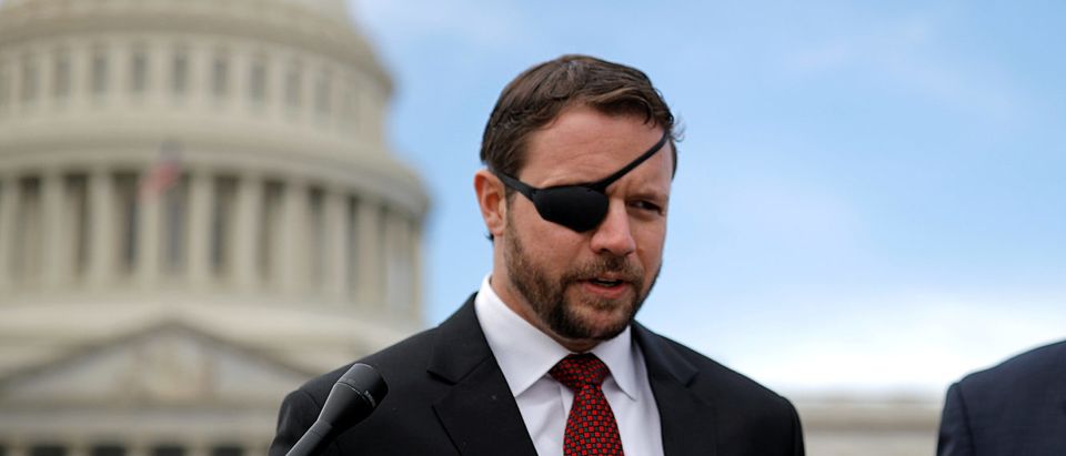 Republican Representative-elect Dan Crenshaw talks with reporters as he arrives for a class photo with incoming newly elected members of the U.S. House of Representatives on Capitol Hill in Washington, U.S., November 14, 2018. REUTERS/Carlos Barria