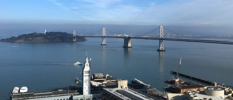 The San Francisco-Oakland Bay Bridge is seen behind the Embarcadero in San Francisco