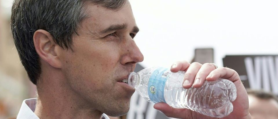 Former Texas Congressman Beto ORourke takes a drink of water while listening to his wife, Amy O'Rourke speak before his presidential kickoff campaign in downtown El Paso, Texas on March 30, 2019 (PAUL RATJE/AFP/Getty Images)