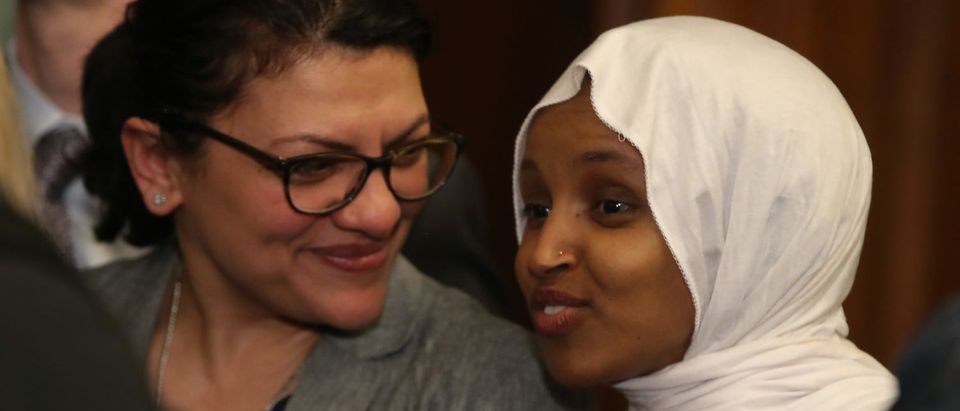 Rep. Ilhan Oma (R) and Rep. Rashida Tlaib attend a news conference where House and Senate Democrats introduced the Equality Act of 2019 which would ban discrimination against lesbian, gay, bisexual and transgender people, on March 13, 2019 in Washington, D.C. (Photo by Mark Wilson/Getty Images)
