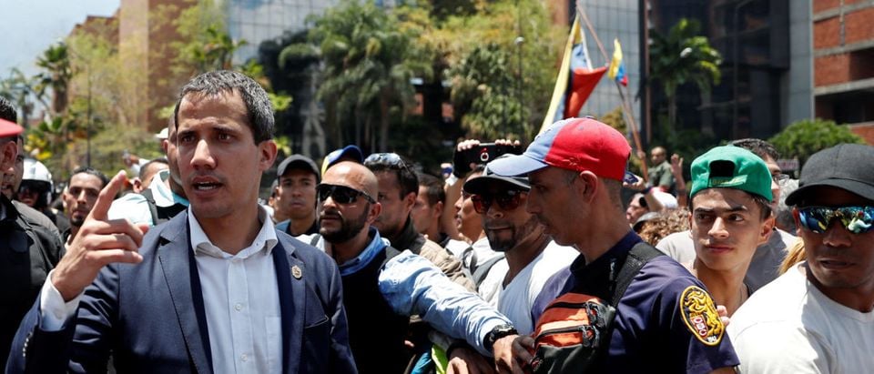 Venezuelan opposition leader Juan Guaido, who many nations have recognised as the country's rightful interim ruler, walks with supporters in Caracas, Venezuela April 30, 2019. REUTERS/Carlos Garcia Rawlins