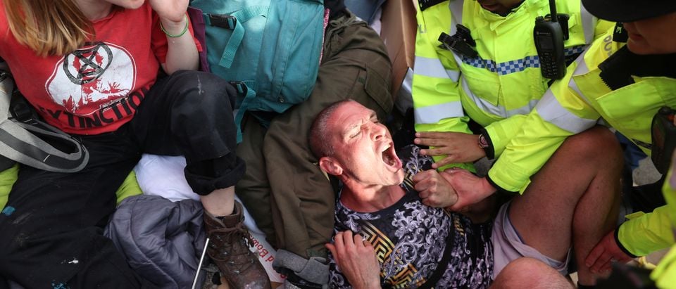 Police officers detain climate change activists at Oxford Circus during the Extinction Rebellion protest in London, Britain April 18, 2019. REUTERS/Simon Dawson.