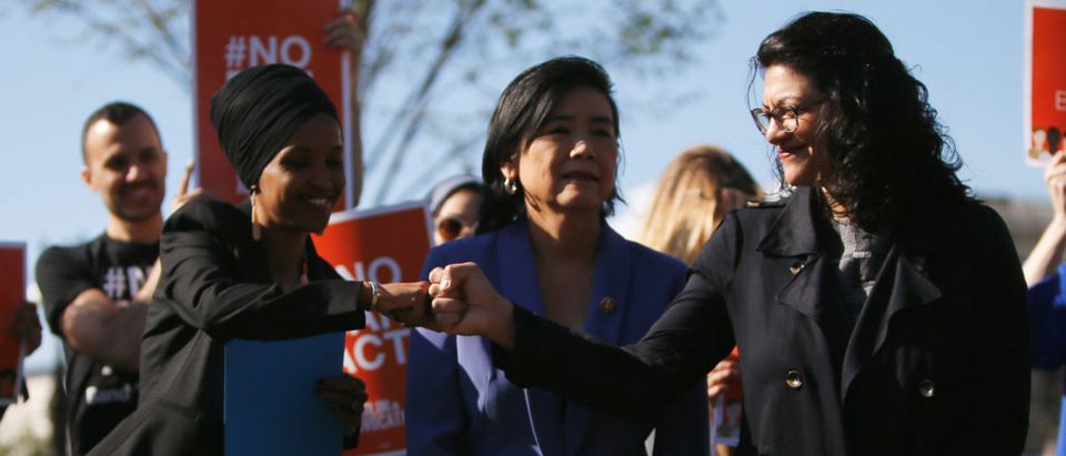 Rep. Omar shares a fist bump with Rep Tlaib during news conference outside U.S. Capitol in Washington