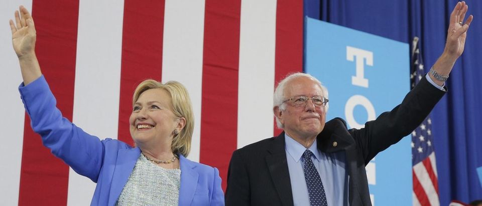 Democratic U.S. presidential candidate Hillary Clinton and Sen. Bernie Sanders stand together during a campaign rally where Sanders endorsed Clinton in Portsmouth, New Hampshire, U.S., July 12, 2016. REUTERS/Brian Snyder