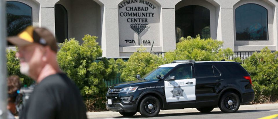 Neighborhood residents and members of the media stansd befoe the Chabad of Poway Synagogue after a shooting on Saturday, April 27, 2019 in Poway, California. - A gunman opened fire at a synagogue in California, killing one person and injuring three others including the rabbi as worshippers marked the final day of Passover, officials said Saturday, April 27, 2019. The shooting in the town of Poway came exactly six months after a white supremacist shot dead 11 people at Pittsburgh's Tree of Life synagogue -- the deadliest attack on the Jewish community in the history of the United States.