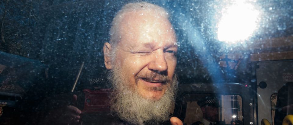 Julian Assange gestures to the media from a police vehicle on his arrival at Westminster Magistrates court on April 11, 2019 in London, England. (Photo by Jack Taylor/Getty Images)