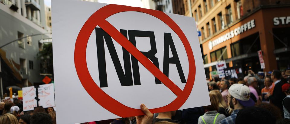 A protester holds an anti-NRA sign during the March for Our Lives rally on March 24, 2018 in Los Angeles, United States. (Photo by Mario Tama/Getty Images)