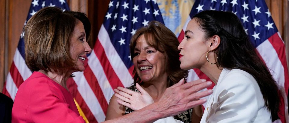 Rep. Alexandria Ocasio-Cortez (D-NY) greets Speaker of the House Nancy Pelosi (D-CA) before a ceremonial swearing-in picture on Capitol Hill in Washington, U.S., January 3, 2019. REUTERS/Joshua Roberts