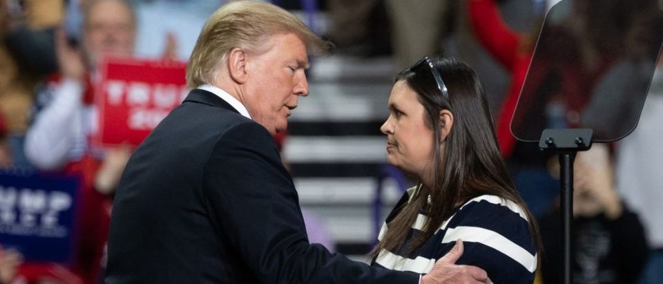 US President Donald Trump (L) embraces White House Press Secretary Sarah Huckabee Sanders during a Make America Great Again rally in Green Bay, Wisconsin, April 27, 2019. SAUL LOEB/AFP/Getty Images