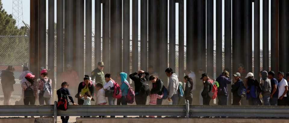 Migrants queue to request asylum after crossing illegally into El Paso