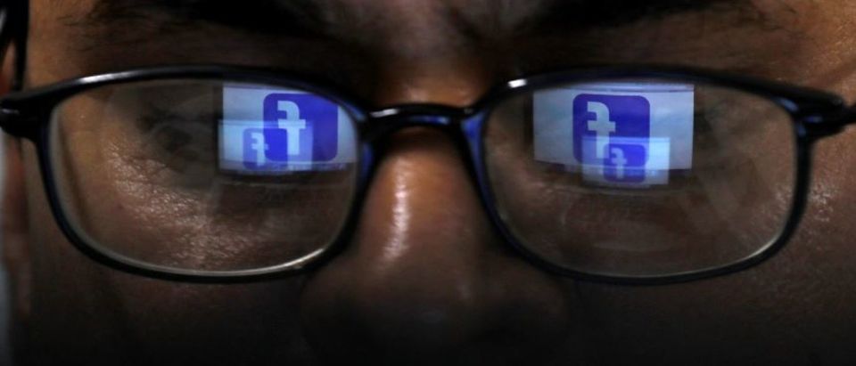 Facebook logo is reflected in glasses in this picture illustration taken April 1, 2019. REUTERS/Akhtar Soomro/Illustration