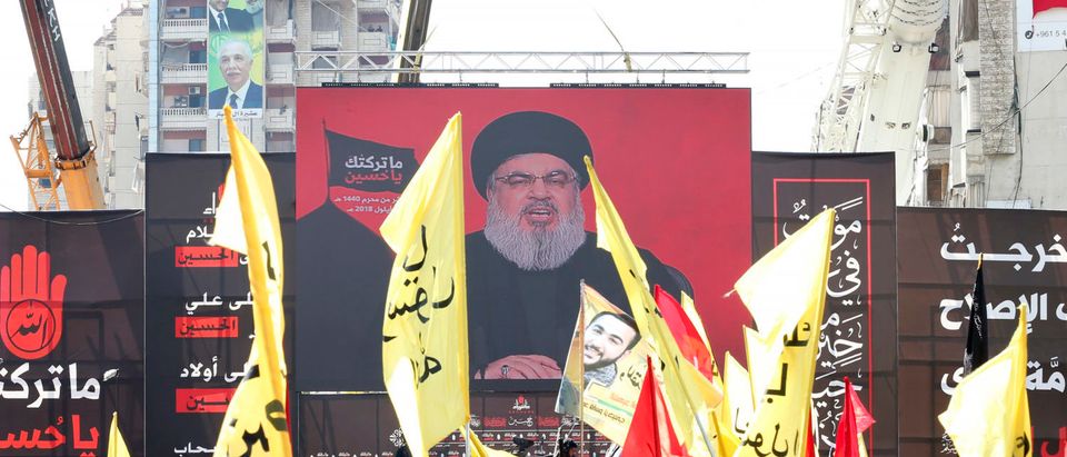 Supporters of Lebanon's Shiite movement Hezbollah gather near a giant poster of their leader Hassan Nasrallah during a ceremony to mark Ashura on Sept. 20, 2018 in Beirut, Lebanon. (Photo by ANWAR AMRO/AFP/Getty Images)