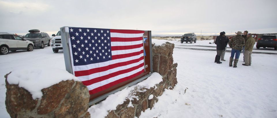 A U.S. flag covers a sign at the entrance of the Malheur National Wildlife Refuge near Burns, Oregon, U.S. January 3, 2016. REUTERS/Jim Urquhart