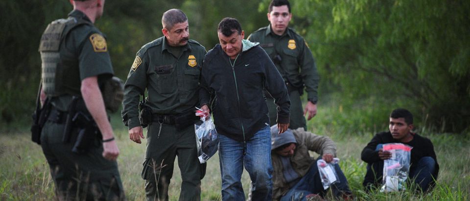 U.S. Border Patrol agents apprehend undocumented migrants after they illegally crossed the U.S.-Mexico border in Mission