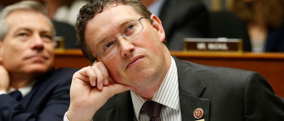 Representative Thomas Massie (R-KY) watches a live downlink with American astronauts aboard the International Space Station (ISS) Navy Commander G. Reid Wiseman (L) and Steven Swanson at the House Science, Space, and Technology Committee on Capitol Hill in Washington, July 24, 2014. REUTERS/Yuri Gripas (UNITED STATES - Tags: POLITICS SCIENCE TECHNOLOGY)
