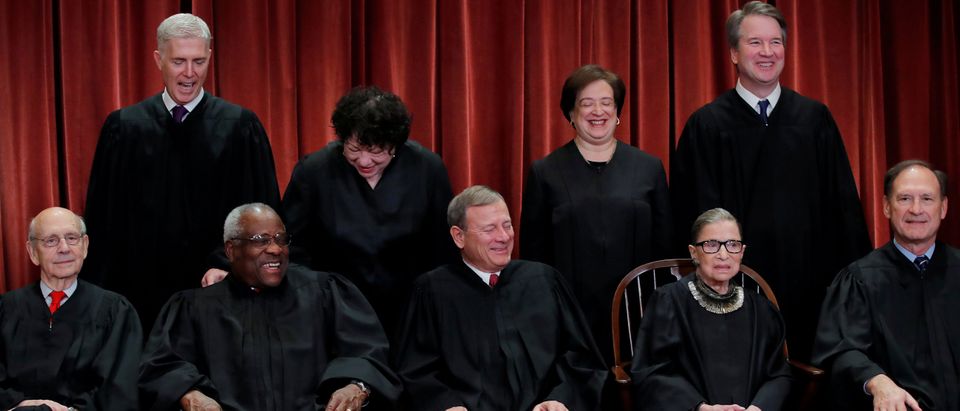 U.S. Supreme Court justices pose for group portrait at the Supreme Court in Washington