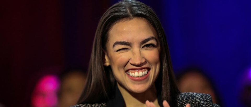 U.S. Rep. Alexandria Ocasio-Cortez winks to audiences following a televised town hall event on the Green New Deal in the Bronx borough of New York City, New York, U.S., March 29, 2019. REUTERS/Jeenah Moon