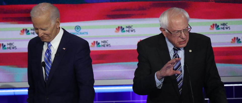 Former Vice President Joe Biden and Sen. Bernie Sanders take part in the second night of the first Democratic presidential debate in Miami, Florida on June 27, 2019. (Drew Angerer/Getty Images)