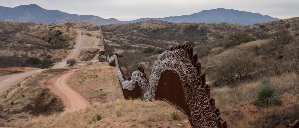 A general view of the US border fence, covered in concertina wire, separating the US and Mexico, at the outskirts of Nogales, Arizona, on February 9, 2019. (Photo by Ariana Drehsler / AFP) (Photo credit should read ARIANA DREHSLER/AFP/Getty Images)
