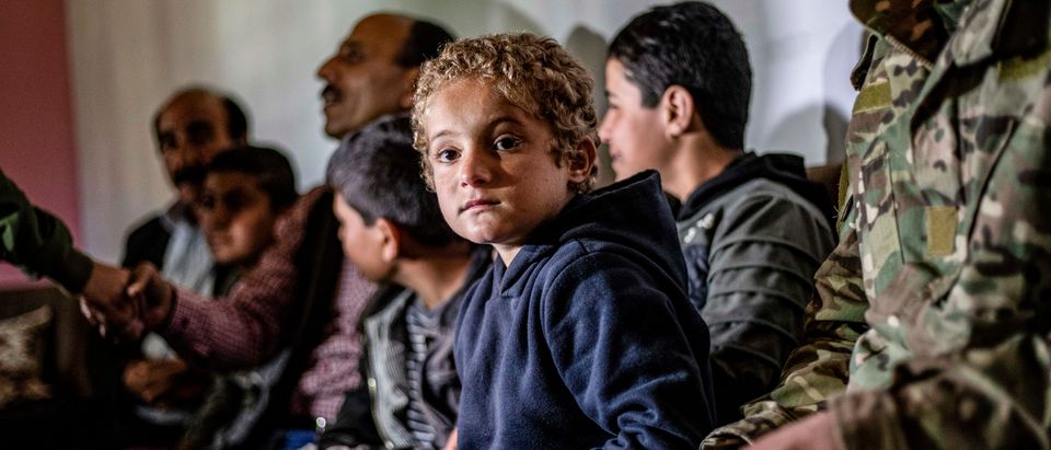 Iraqi Yazidi children rescued from the Islamic State (IS) group waiting to board buses bound for Sinjar in Iraq's Yazidi heartland. (DELIL SOULEIMAN/AFP/Getty Images)