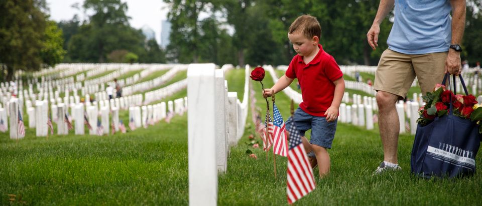 Volunteers Place Flowers On Gravesites At Arlington National Cemetery Ahead Of Memorial Day