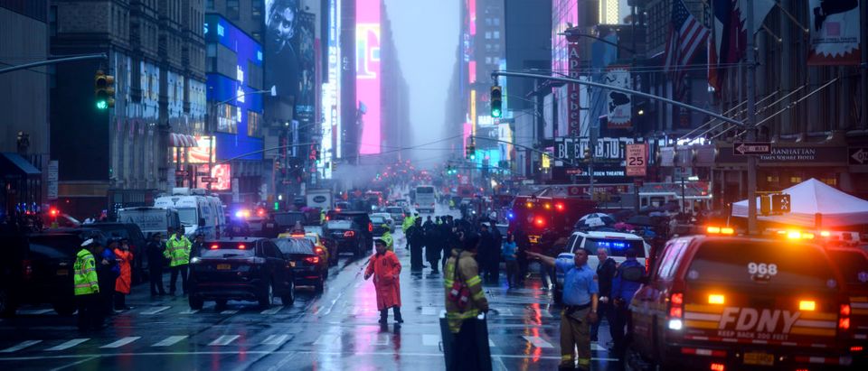 Policemen stand near emergency services vehicles after a helicopter crash-landed on top of a building in midtown Manhattan in New York on June 10, 2019. (JOHANNES EISELE/AFP/Getty Images)