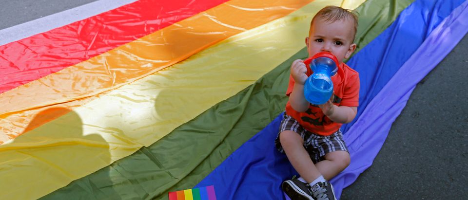 A child drinks water on the rainbow flag during Romania's gay community Gay Fest 2014 pride parade in Bucharest (ROMANIA - Tags: SOCIETY) - GM1EA68019801