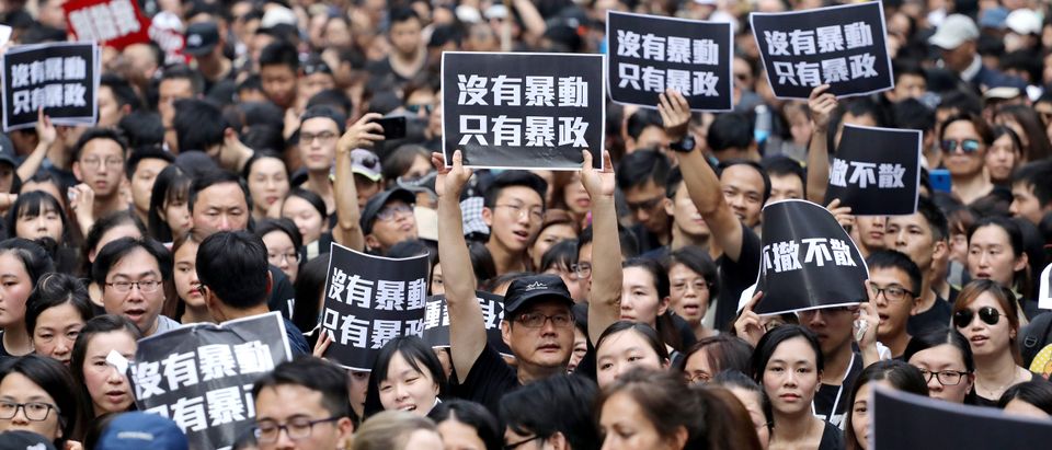 Protesters hold placards as they attend a demonstration demanding Hong Kong's leaders to step down and withdraw the extradition bill, in Hong Kong, China, June 16, 2019. REUTERS/Athit Perawongmetha.