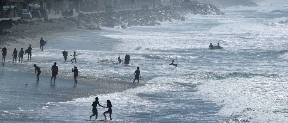 People cool off at the beach during a Southern California heat wave in Oceanside, California