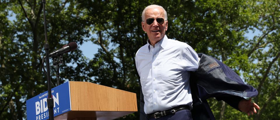 Democratic 2020 U.S. presidential candidate Biden takes off his jacket as he arrives onstage for a campaign rally in Philadelphia, Pennsylvania