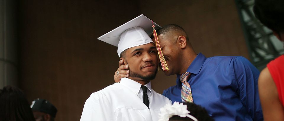 McDonogh graduate Malik Hayes hugged by his father Marlon. Mario Tama/Getty Images.