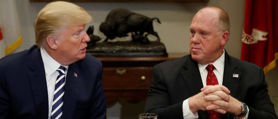 U.S. President Donald Trump speaks to Thomas Homan, acting director of U.S. Immigration and Customs Enforcement, during a round table meeting with members of law enforcement about sanctuary cities in the Roosevelt Room at the White House in Washington, U.S., March 20, 2018. REUTERS/Leah Millis