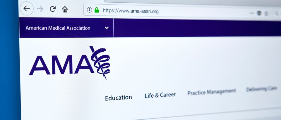 A screen shows the American Medical Association's webage. Shutterstock image via chrisdorney