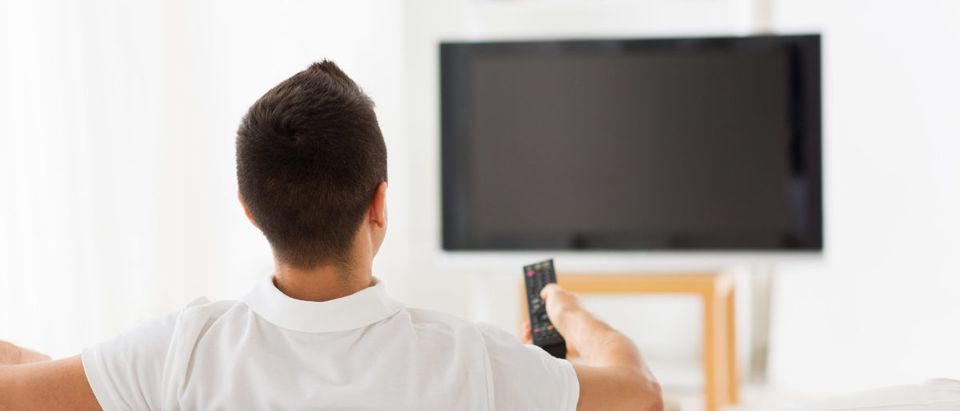 A man watches television. Shutterstock image via Syda productions