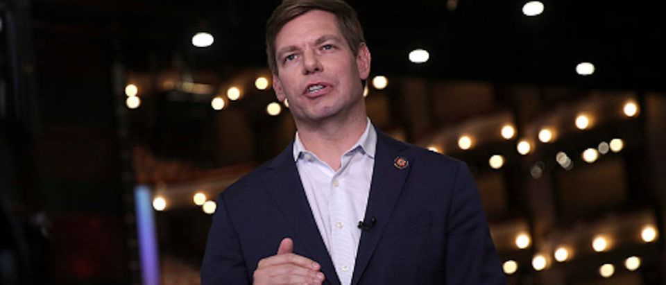 Democratic presidential candidate Rep. Eric Swalwell (D-CA) does a television interview in the spin room before the second night of the first Democratic presidential debate on June 27, 2019