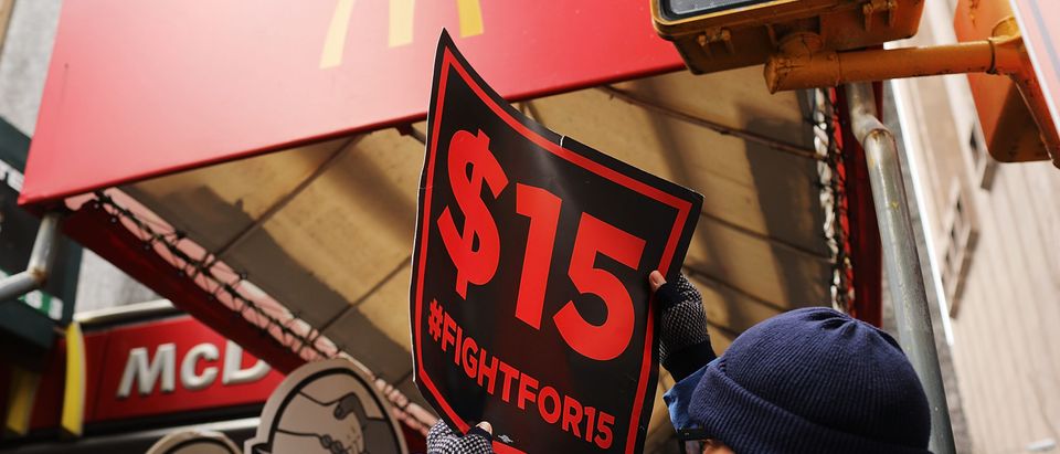 NEW YORK, NY - FEBRUARY 13: Protesters with NYC Fight for $15 gather in front of a McDonalds to rally against fast food executive Andrew Puzder, who is President Donald Trump's nomination to lead the Labor Department on February 13, 2017 in New York City. Puzder's fast food business, including Hardee's and Carl's Jr., have a mixed record with workers, with many claiming him hostile to workers rights. (Photo by Spencer Platt/Getty Images)