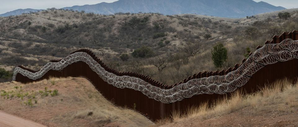 A general view of the US border fence, covered in concertina wire, separating the US and Mexico, at the outskirts of Nogales, Arizona, on February 9, 2019. (ARIANA DREHSLER/AFP/Getty Images)