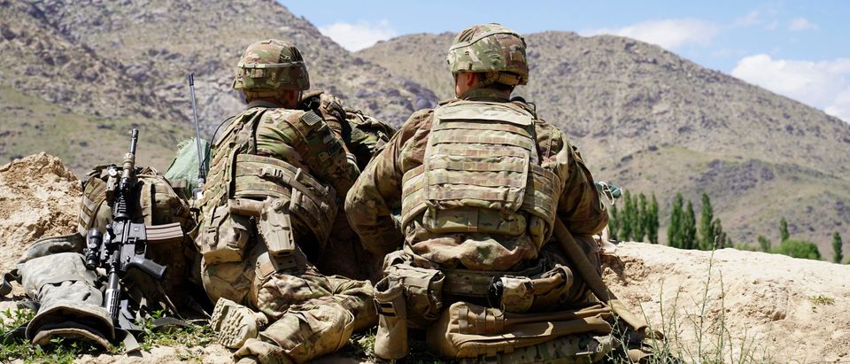In this photo taken on June 6, 2019, US soldiers look out over hillsides during a visit of the commander of US and NATO forces in Afghanistan General Scott Miller at the Afghan National Army (ANA) checkpoint in Nerkh district of Wardak province. - A skinny tangle of razor wire snakes across the entrance to the Afghan army checkpoint, the only obvious barrier separating the soldiers inside from any Taliban fighters that might be nearby. (Photo by THOMAS WATKINS / AFP) / To go with 'AFGHANISTAN-CONFLICT-MILITARY-US,FOCUS' by Thomas WATKINS (Photo credit should read THOMAS WATKINS/AFP/Getty Images)