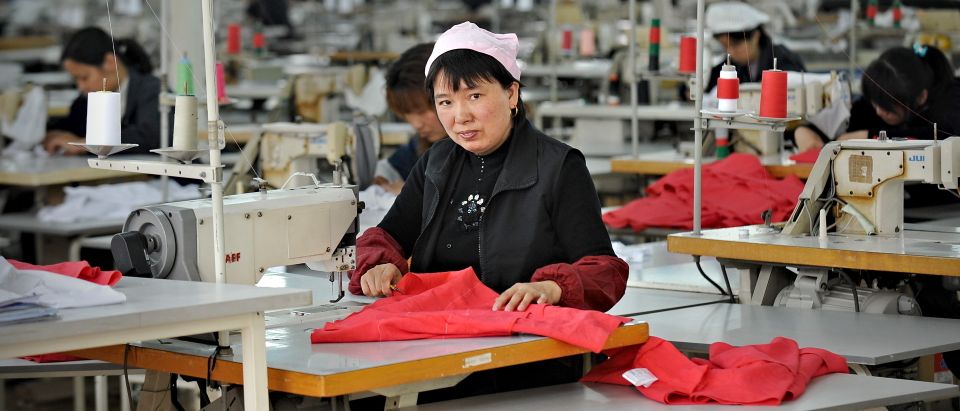 A Chinese worker looks on from her work station at a garment factory in Pinghu some 100 kms from Shanghai on April 10, 2010. China posted its first monthly trade deficit in six years in March 2010 as imports rocketed, far outstripping the growth in exports, customs officials announced on April 10, 2010. AFP PHOTO/PHILIPPE LOPEZ (Photo: PHILIPPE LOPEZ/AFP/Getty Images)