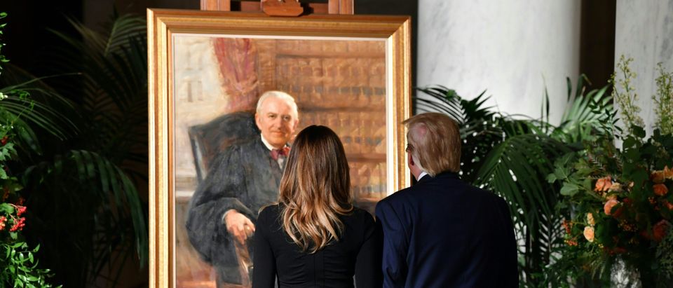 President Donald Trump and first lady Melania Trump look at a portrait of the late Justice John Paul Stevens in the Great Hall of the Supreme Court on July 22, 2019. (Nicholas Kamm/AFP/Getty Images)